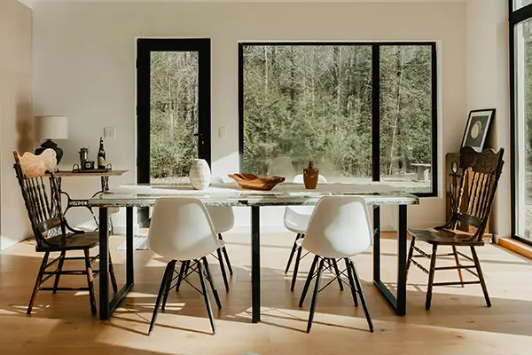 Armchair at the head of a dining table with different side chairs showing dining room hierarchy